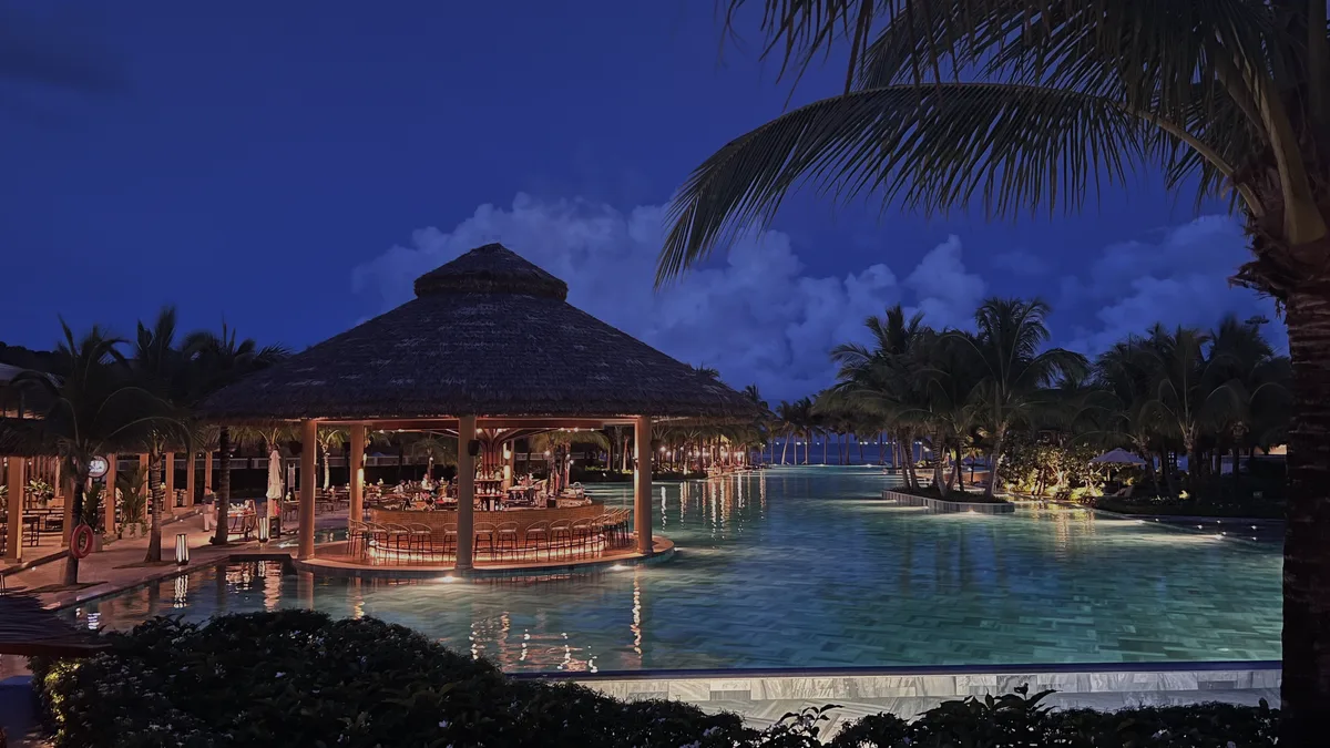 A tourist using a digital passport app at a local cafe to track regional spending and economic impact.