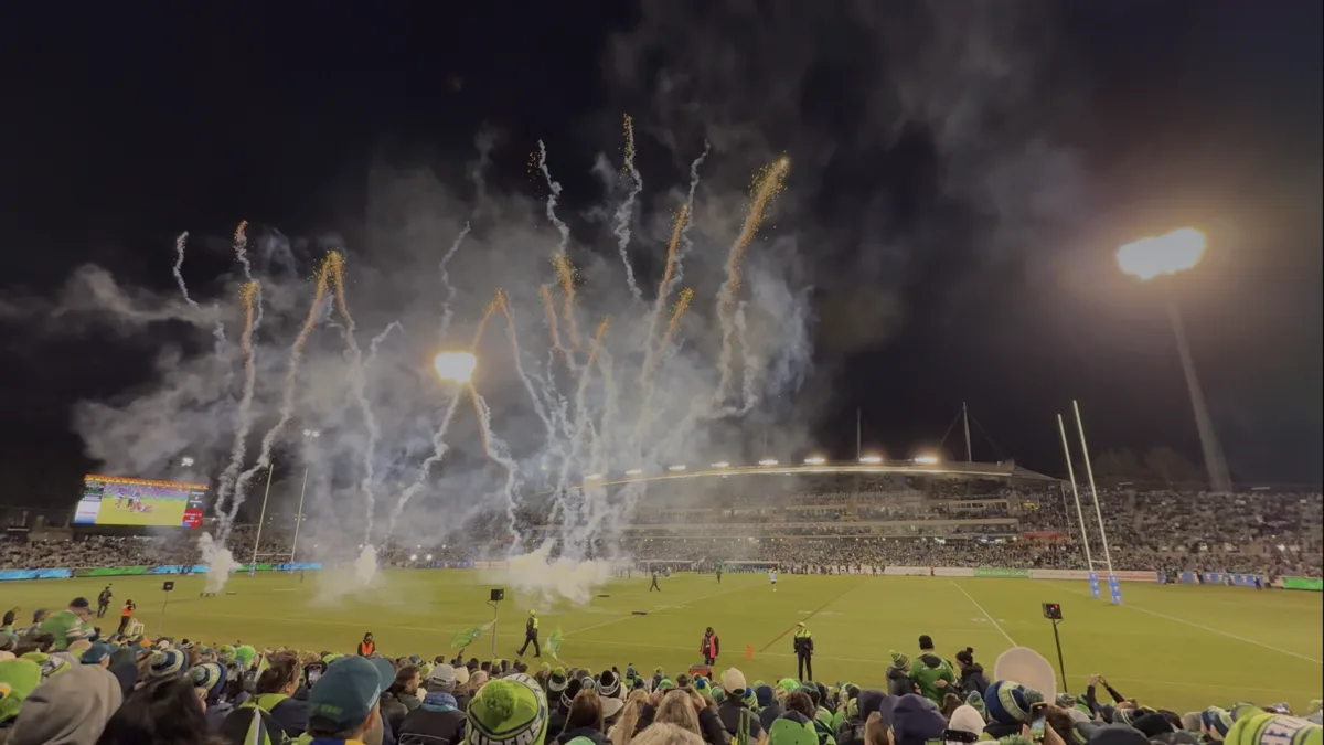 Smartphone displaying a digital game-day ticket and QR code at a sports stadium entrance